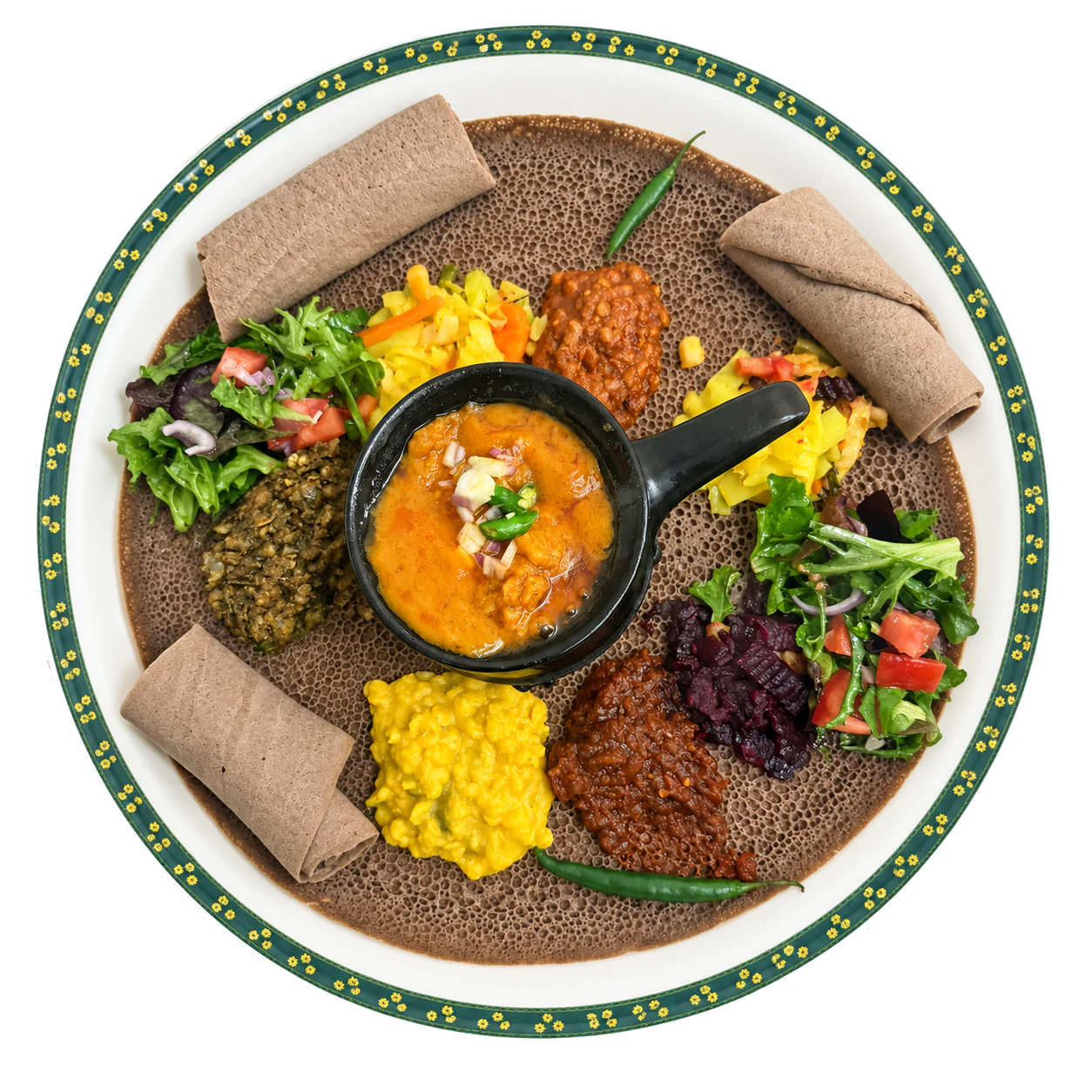 Vegetarian injera platter with a small pan of orange shiro, lentils, yellow split peas, beetroot, vegetables and salad